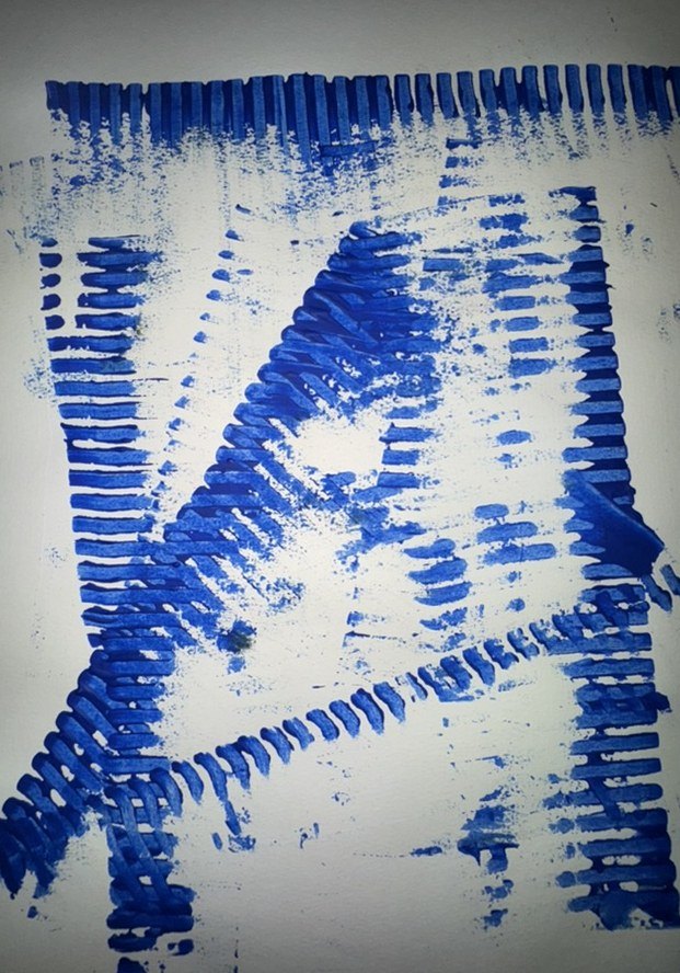 Blue comb-printed marks forming an angular shape on white paper