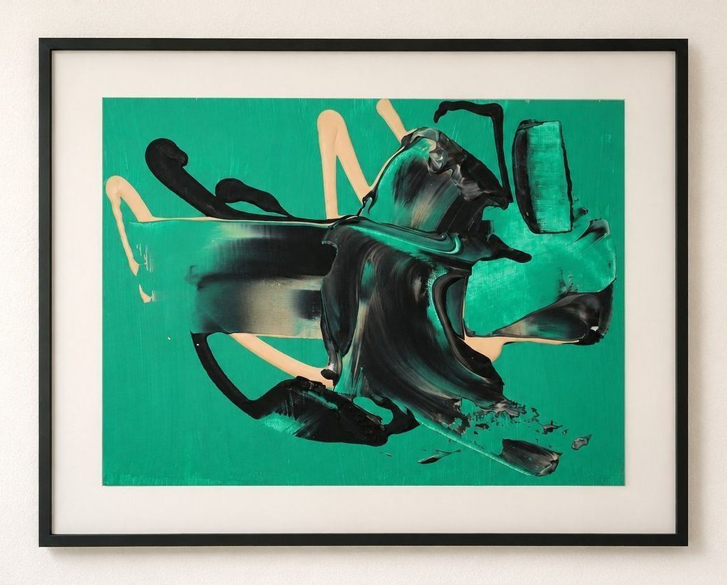 An emerald green work on paper with black and peach strokes, in a black frame