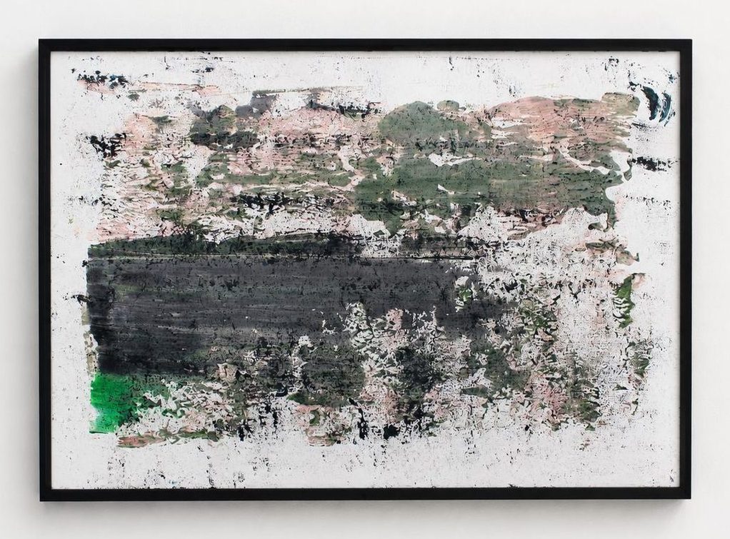 A white work on paper with a black band and green and pink marks, in a black frame