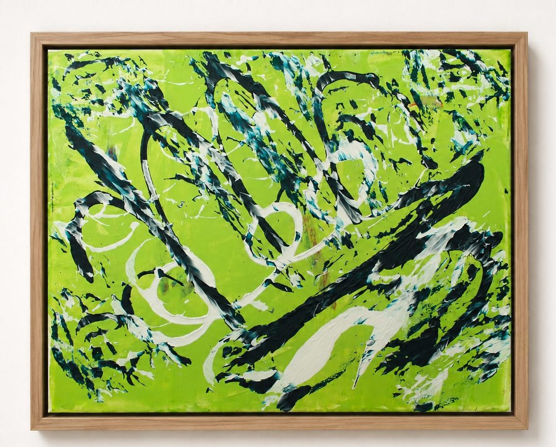 Black and white marks on a lime green ground, in a pale oak frame