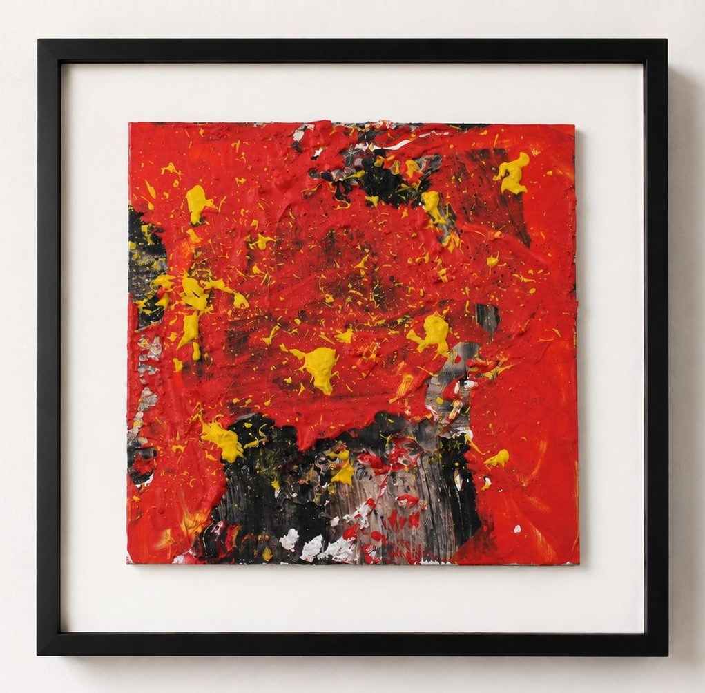 Black and yellow marks on a red ground, in a black frame