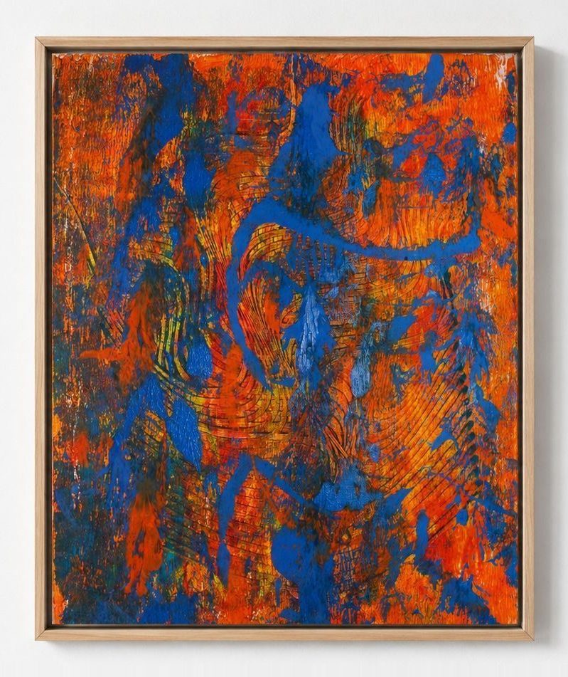 An orange canvas with heavy blue strokes, in an oak frame