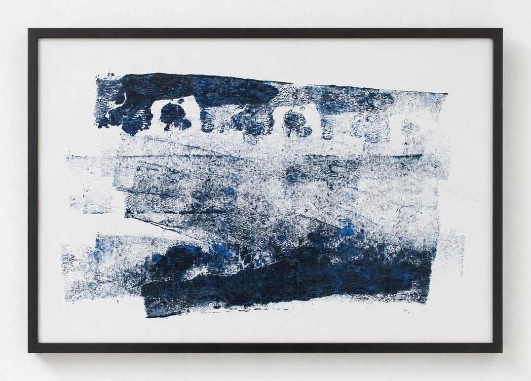 A navy monotype in layered bands, in a black frame