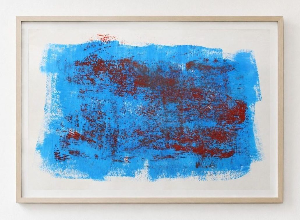 A bright blue work with dark red scraped through it, in a pale frame