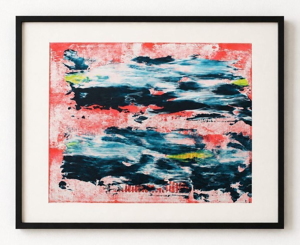A red and navy wave painting, in a black frame