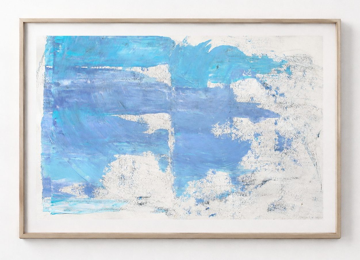 A blue and white cloudy field on paper, in a black frame